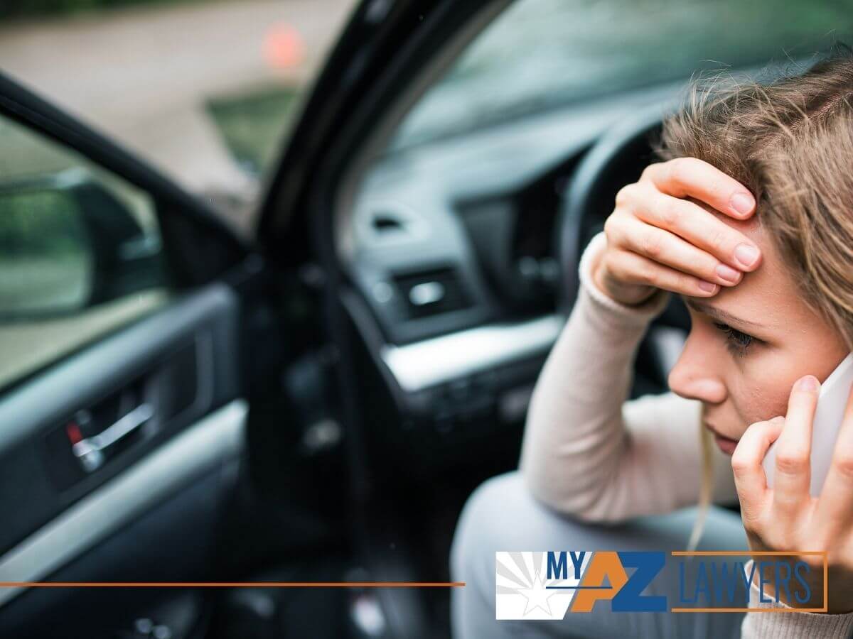 Young woman in a phone call after a car accident in Arizona