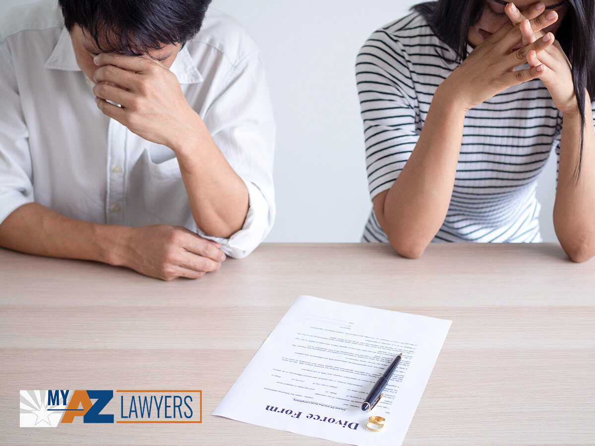 Stressed Out Couple Signing A Divorce Form In Mesa, AZ