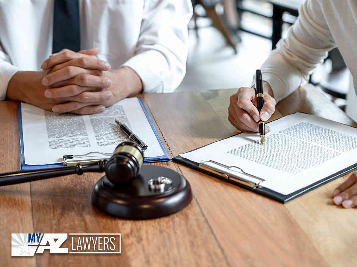 A couple with a long marriage signing divorce papers in Tucson, AZ.