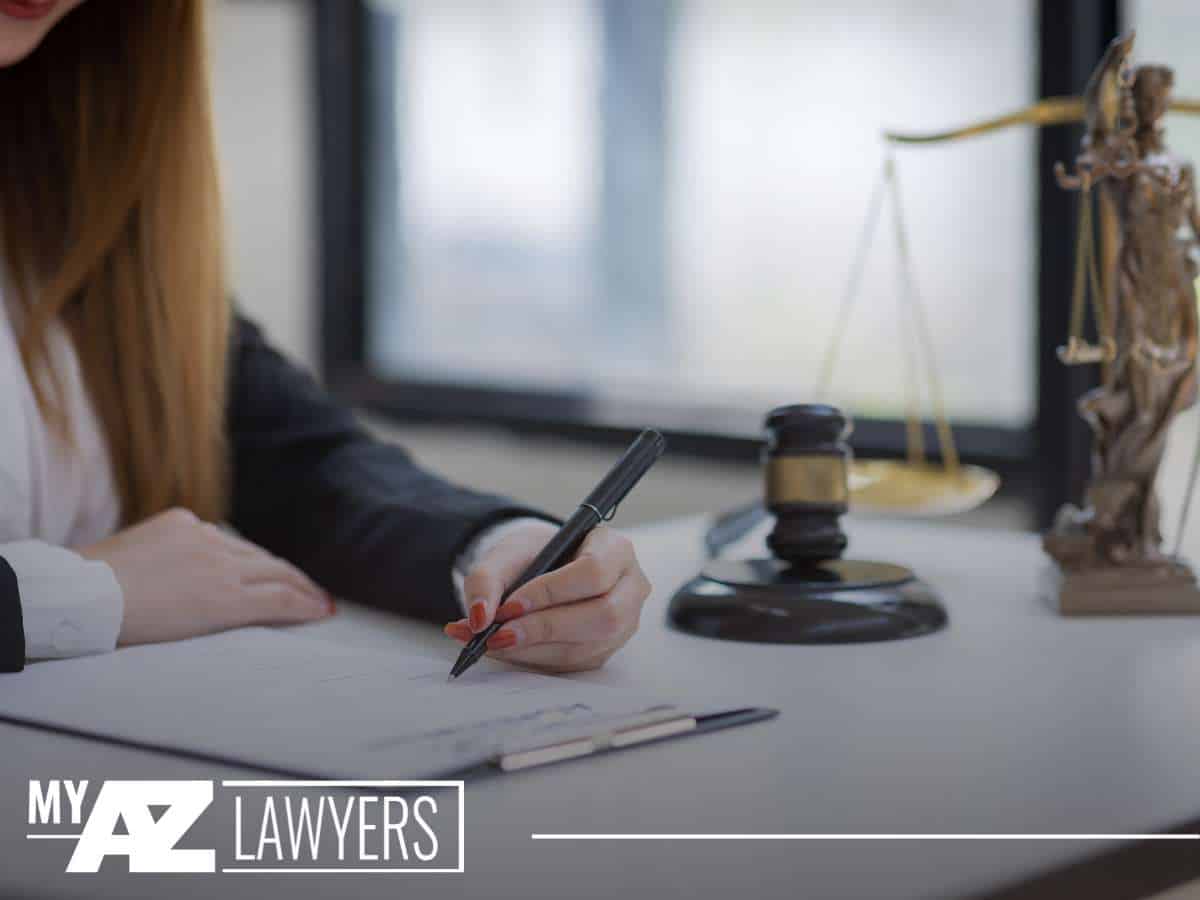 Family law lawyer working at a desk with legal scales and a gavel in the background.